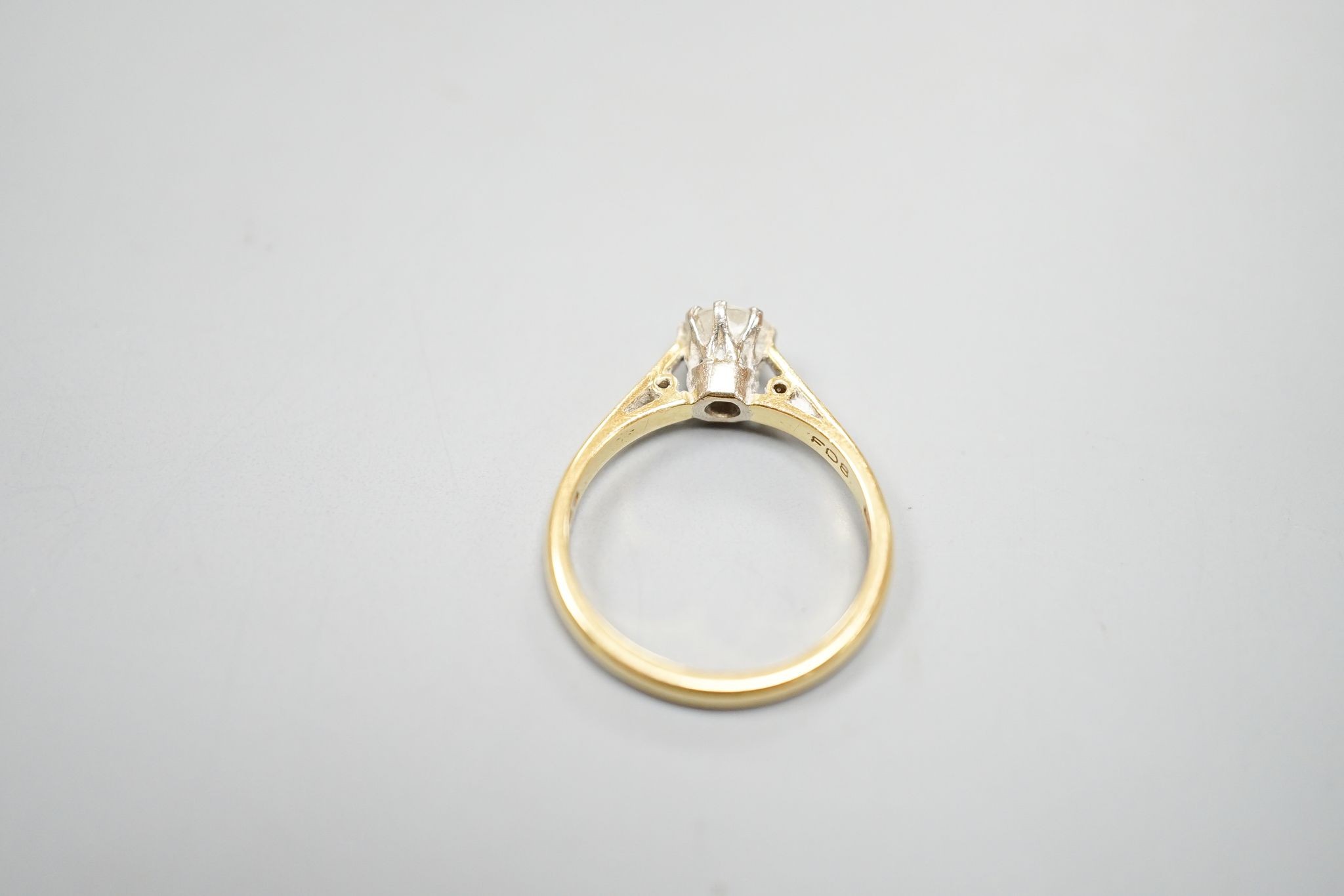 A modern 18ct gold and solitaire diamond ring, size N, gross weight 3.5 grams